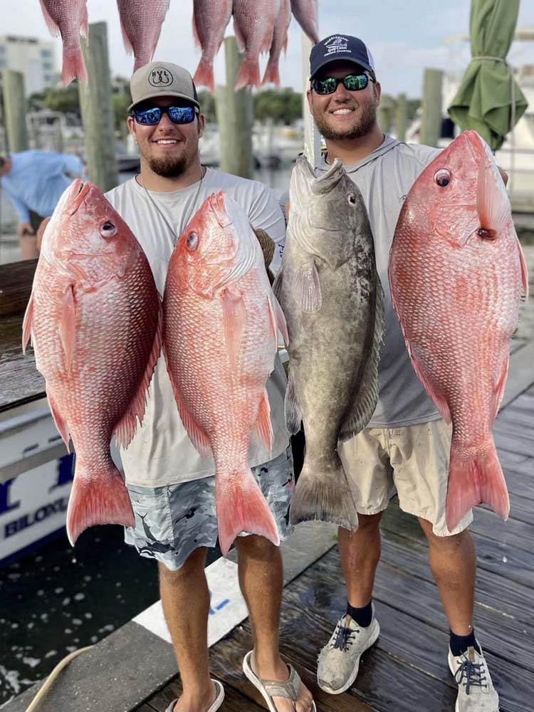 Captain chance and 1st mate Tommy holding some nice snapper and a gag grouper.