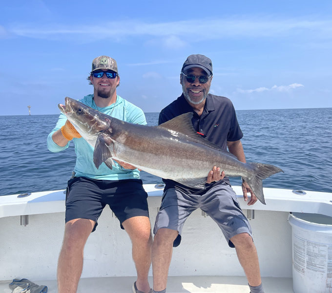 1st mate Tommy helping hold up 50lb cobia