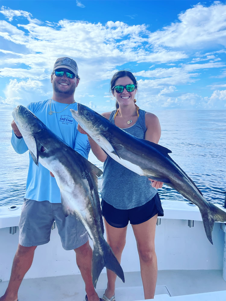 Captain chance and his wife holding two nice cobia!